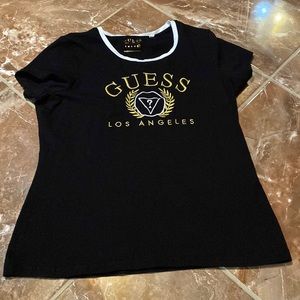 A gold and black Guess tee in XXL.